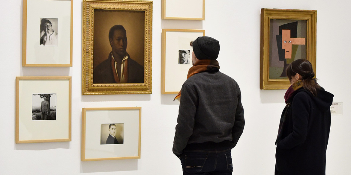 Visiteurs devant un accrochage d'oeuvres de la collection du musée
